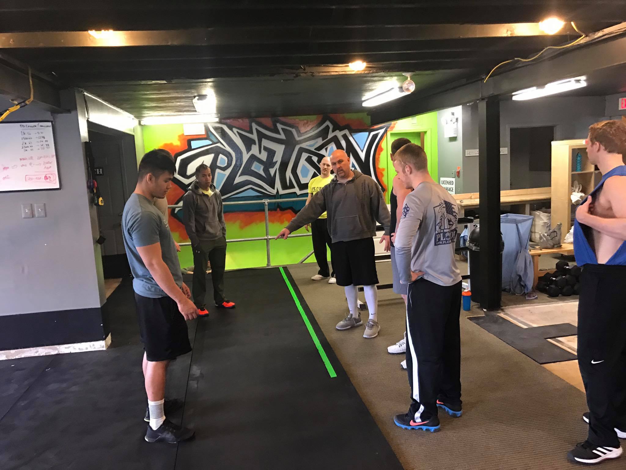 A group of men standing around in a room.