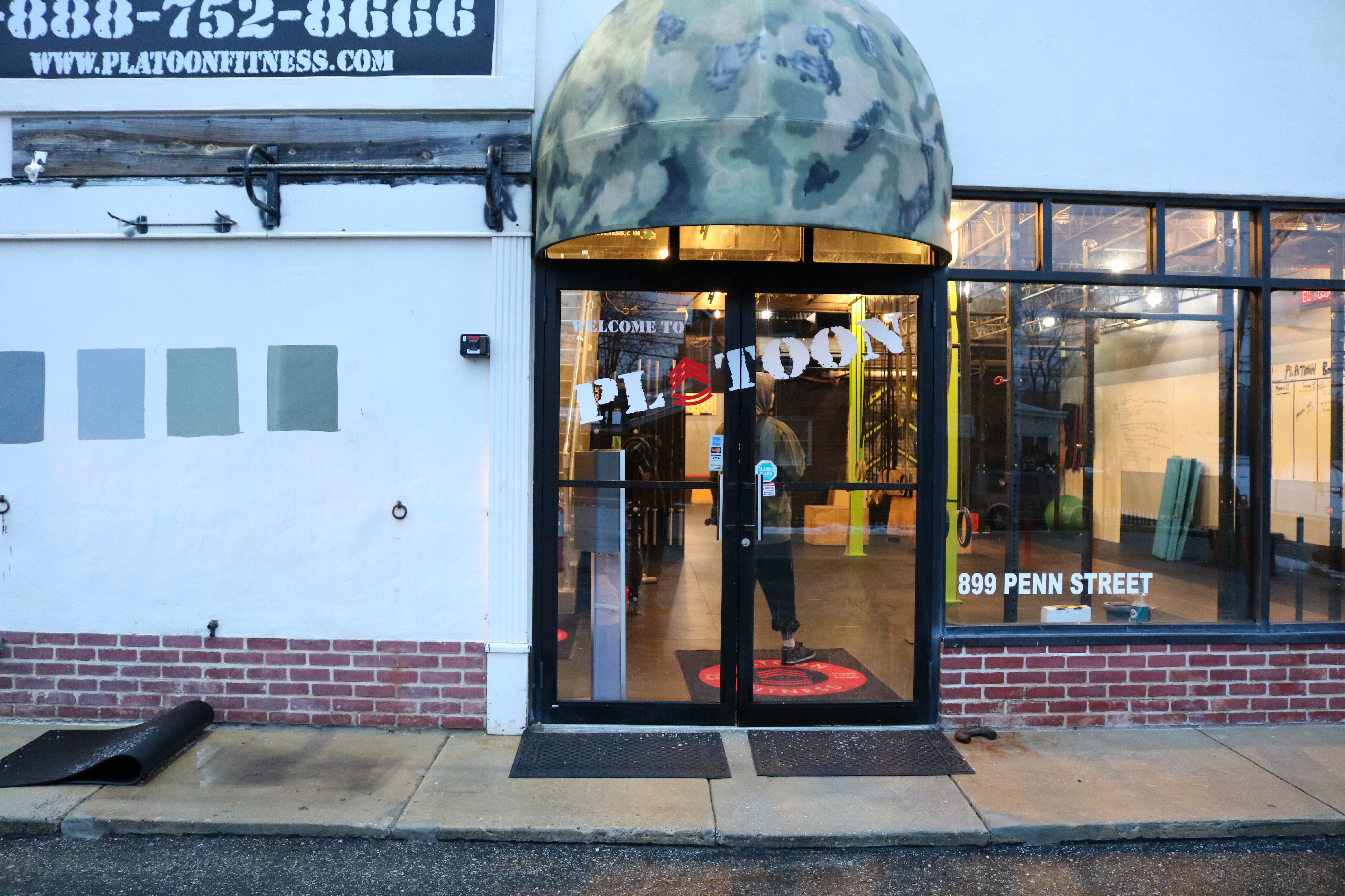 A person walking in front of a store.