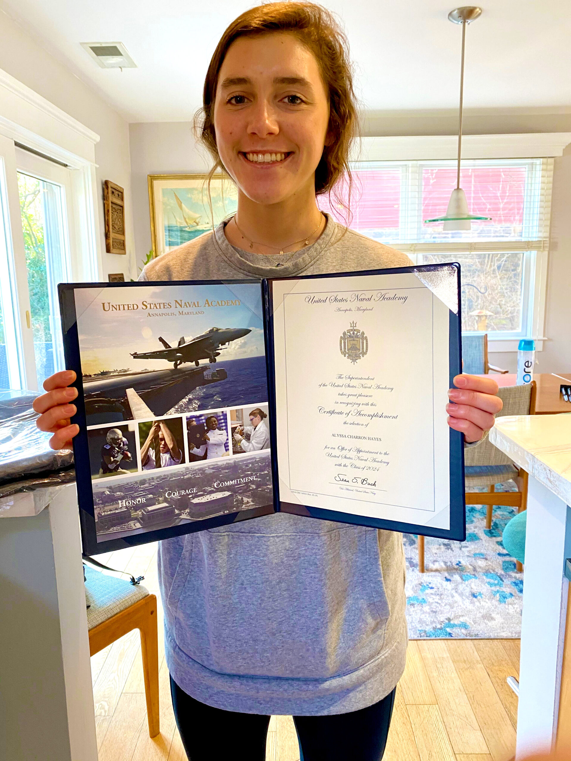 A woman holding an airplane picture in her hands.