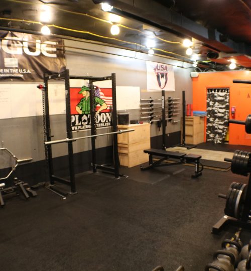 A gym with many different equipment in it